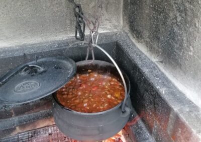 Food cooking in a black pot potjiekos